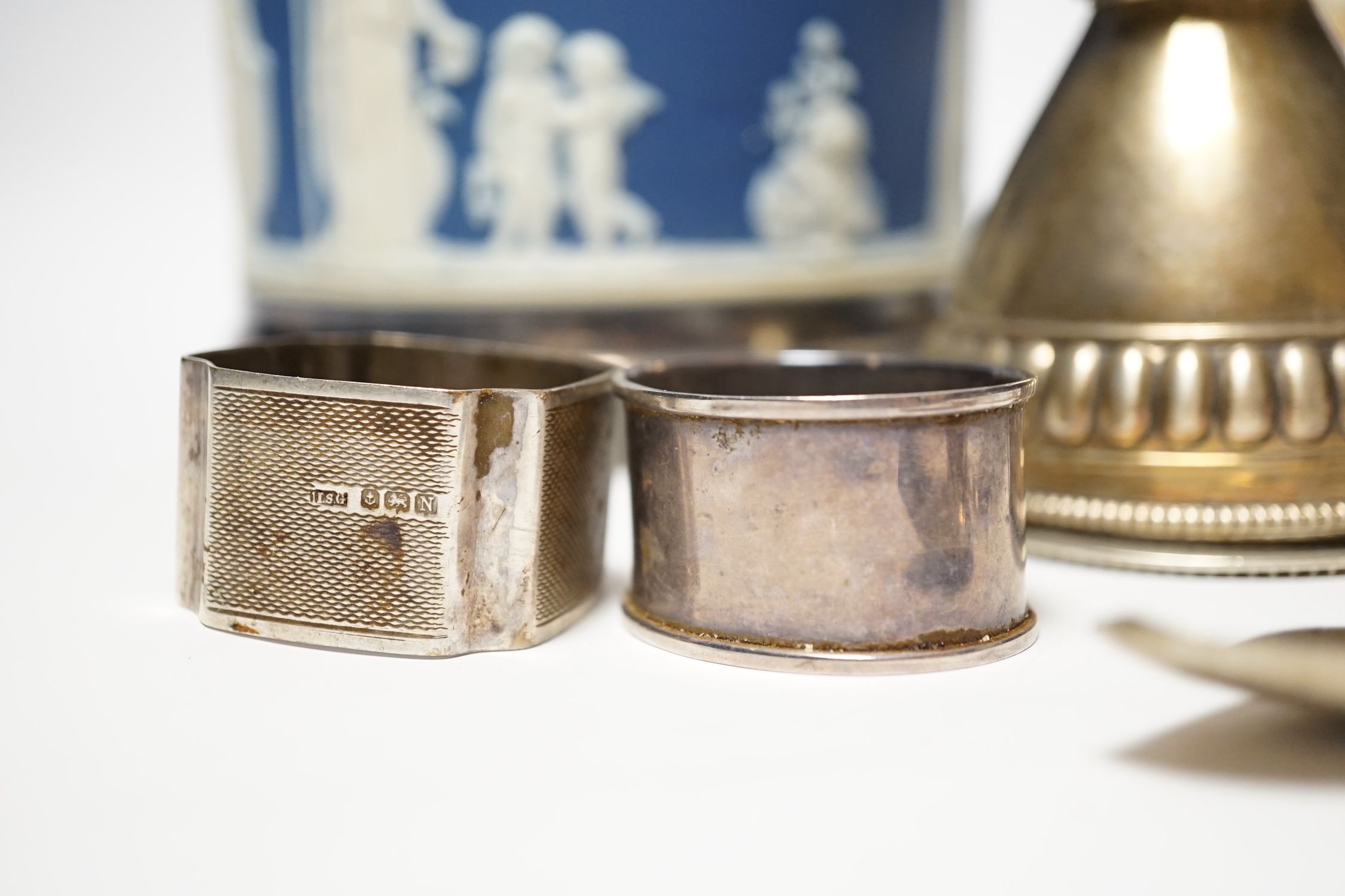 A silver sugar caster, serviette rings, a plated wine funnel, a Wedgwood biscuit barrel, etc.